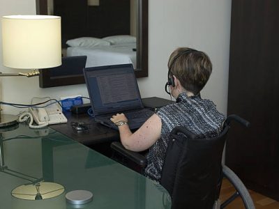 woman with disability working from a hotel room woman with disability working from a hotel room